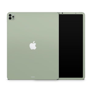 May include: A green iPad Pro with a white Apple logo on the back. The iPad is shown in both front and back views.