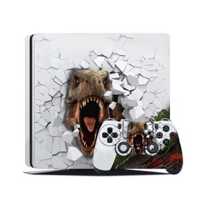 May include: A white PlayStation 4 console and controller with a dinosaur breaking through a cracked wall design. The dinosaur is a Tyrannosaurus Rex with a green, brown, and gray color scheme.