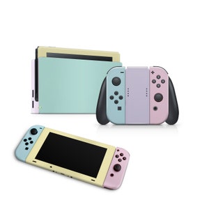 May include: A pastel-colored Nintendo Switch console with a light blue and yellow Joy-Con controller. The console is in handheld mode and the screen is off. The console is on a white background.