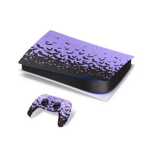 May include: A video game console and a matching wireless controller featuring a purple and black gradient skin. The surface of both items is covered in a repeating pattern of small black bat silhouettes that transition from dense at the bottom to sparse at the top.