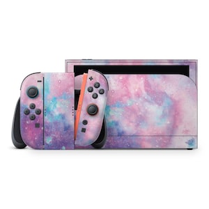 May include: A Nintendo Switch console and Joy-Con controllers, adorned with a galaxy-themed skin. The skin showcases a mix of pink, purple, and blue shades, producing a cosmic appearance. The controllers are connected to the console, and the design covers the whole device.