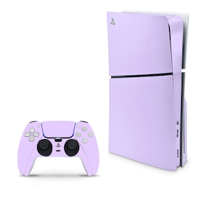 May include: A lavender-colored PlayStation 5 console with a matching lavender-colored controller. The console has a sleek, modern design with a curved front panel. The controller has a standard PlayStation layout with buttons, joysticks, and a touchpad.