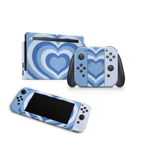 May include: A blue and white Nintendo Switch console and controller with a heart pattern. The console and controller are both decorated with a blue and white heart pattern.