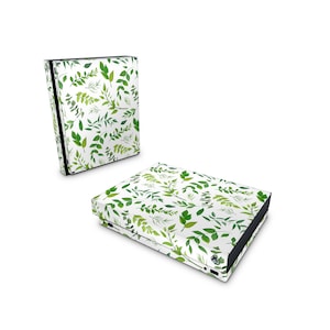 May include: A white Xbox Series X console skin with a green leafy pattern. The skin is designed to fit the console and controller.