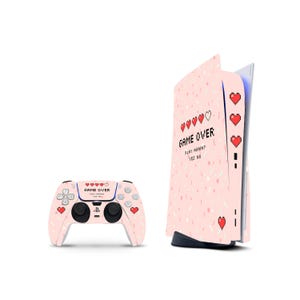 May include: A light pink gaming console and controller skin set featuring a pixelated heart health bar, the text "GAME OVER" and "PLAY AGAIN? YES NO" in a retro font, and scattered small white and pink confetti-like shapes across the surface.