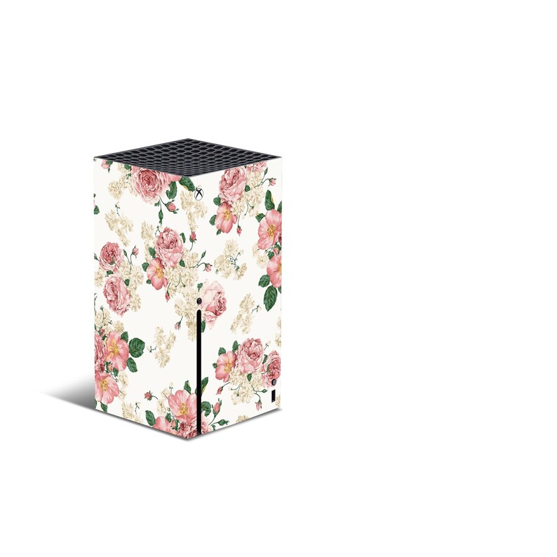 May include: A white gaming console with a floral design featuring pink and white flowers. The console has a black front panel with a small black button.