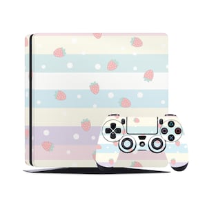 May include: A white PlayStation 4 console and controller with a pastel pink, yellow, blue, and purple striped pattern and a scattered strawberry design.