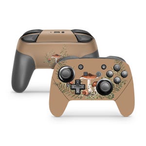 May include: Two tan-colored game controllers with a mushroom and fern design. The controllers have black buttons and joysticks. The design features brown mushrooms and green ferns. The controllers are designed for gaming.