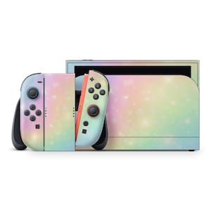 May include: A Nintendo Switch console with a pastel rainbow galaxy design. The console includes two Joy-Con controllers and a dock, all featuring a gradient of soft colors and a starry pattern. The controllers have black buttons and joysticks.