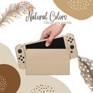 May include: A beige Nintendo Switch console and dock set. The console is held by a hand, with the text "Natural Colors" and "Choose your favorite" in the background. Decorative feathers and brown shapes complete the design.
