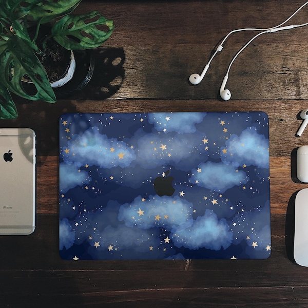 May include: A laptop skin with a blue and gold starry night design. The design features clouds and stars on a dark blue background.