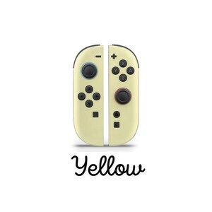 May include: A pair of yellow game controllers with black buttons and accents. The controllers feature various buttons, including directional pads, action buttons, and control sticks. The word "Yellow" is written in a cursive font below.