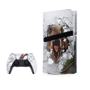 May include: A white PlayStation 5 console skin with a graphic of a dinosaur breaking through a wall. The skin is designed to fit the console and controller. The controller is also white with a matching dinosaur graphic.