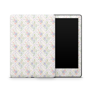 May include: An e-reader with a floral patterned cover. The cover features a repeating pattern of pastel flowers in pink, blue, and purple, set against a cream background with a light purple grid. The e-reader's screen is black.