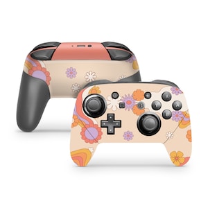 May include: A custom Nintendo Switch controller skin with a retro floral design in shades of pink, orange, and purple on a cream background.
