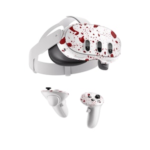 May include: A white virtual reality headset with red blood splatter design. The headset comes with two white controllers with the same red blood splatter design.