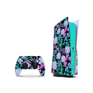 May include: A gaming console and a wireless controller featuring a black skin with a vibrant floral pattern of pink, purple and teal lotus flowers and leaves. The console has a solid teal side panel and the controller has matching buttons.