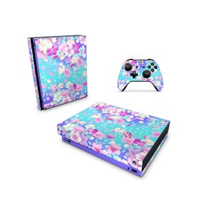 May include: A floral patterned skin for an Xbox Series X console and controller. The design features pink, white, and blue flowers on a light blue background.