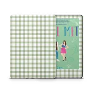 May include: A green and white gingham patterned Kindle cover with the book title "I'll Met" visible. The cover is open, revealing the screen with a book cover illustration. The book cover features a woman in a pink skirt and the author's name.