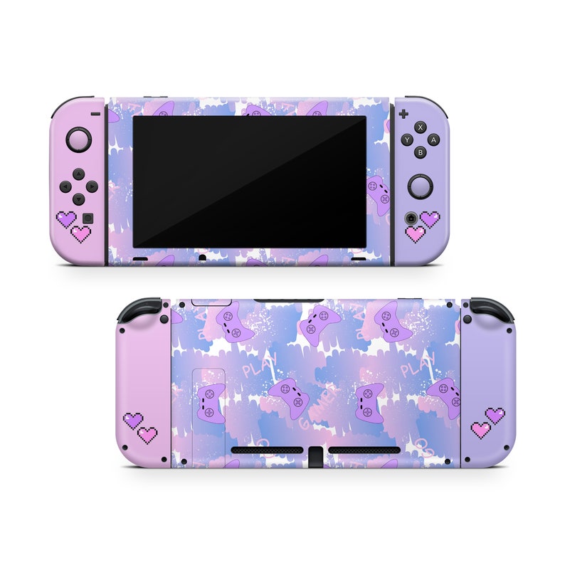 May include: A purple and pink Nintendo Switch console skin with a pattern of purple and pink game controllers and the word "PLAY" on a white background.