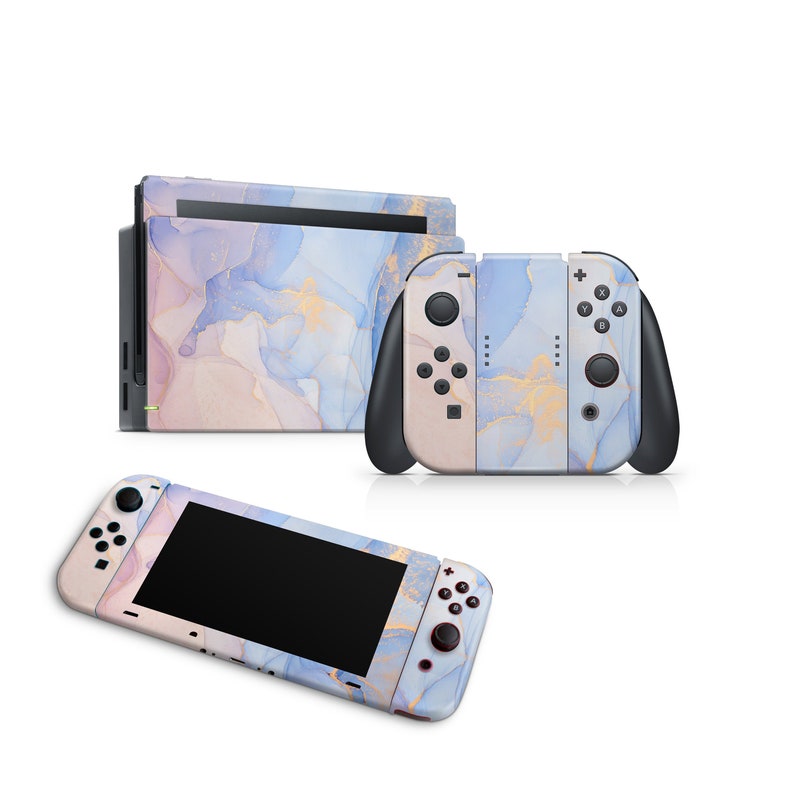 May include: A Nintendo Switch console and two controllers with a blue, pink, and gold marble design.