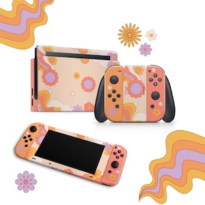 Può includere: Una console Nintendo Switch color pesca con un design retrò floreale e ondulato. La console è mostrata con un controller Joy-Con abbinato.