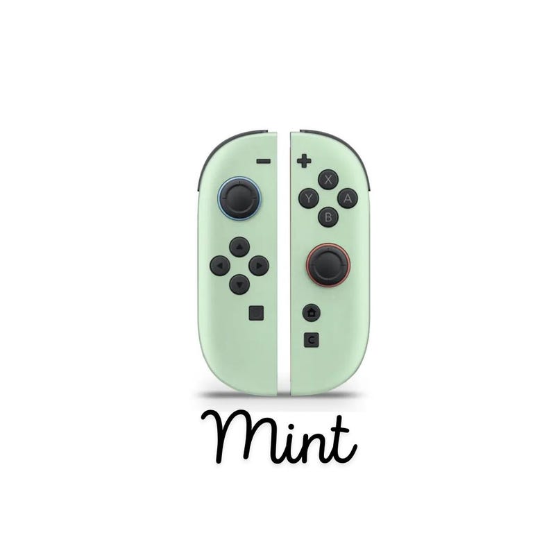 May include: Mint-coloured game controllers with black buttons and joysticks. The controllers have a sleek design with the word "Mint" written in cursive script below. The controllers are designed for gaming.