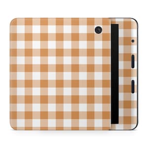 May include: A tablet with a cover featuring a tan and white gingham pattern. The tablet has a black screen and a black border. The cover wraps around the device, with a camera and buttons visible on the side.