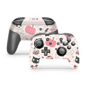 May include: A white Nintendo Switch controller with a pink and black Halloween themed design. The design features pumpkins, skulls, cats, and other spooky elements.