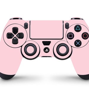 以下が含まれることがあります： 黒いボタンと黒いプレイステーションロゴが付いたピンクのプレイステーション4コントローラー