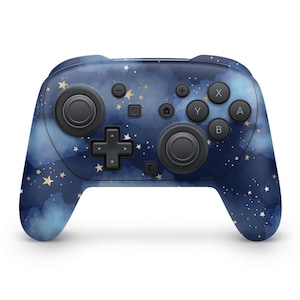 May include: A blue and black games controller with a starry night sky design. The controller has a D-pad, two analogue sticks, and various buttons. The design features white stars and a cloudy background.