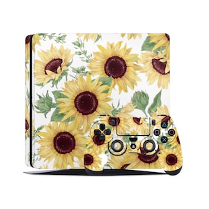 Peut inclure: Une peau pour console PlayStation 4 et manette blanche avec un motif de tournesols. La peau présente des tournesols jaunes avec des centres bruns sur un fond blanc.