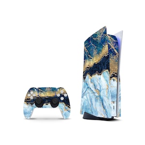 May include: A gaming console and a wireless controller featuring a decorative skin with a blue, white, and gold marble pattern. The design includes swirling shades of deep navy, light blue, and white, accented by metallic gold veins throughout.