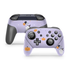 May include: A purple and white Nintendo Switch controller skin with a Halloween theme. The design features ghosts, pumpkins, and stars.