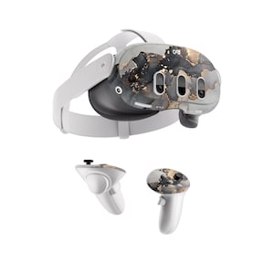 May include: A white virtual reality headset with a black and gold marble design. The headset has two controllers with the same design.