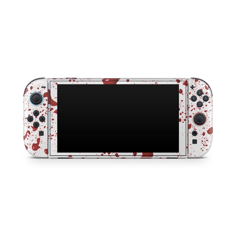 May include: White Nintendo Switch console with a blood splatter design. The console features a black screen and red and black buttons. The Joy-Con controllers and the main body are covered in red splatters.
