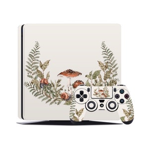 May include: A white PlayStation 4 console and controller with a forest-themed skin. The skin features a mushroom, ferns, and snails in shades of brown, green, and white.
