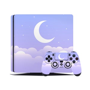 May include: A purple and blue PlayStation 4 console and controller with a crescent moon and clouds design. The console and controller have a night sky theme.