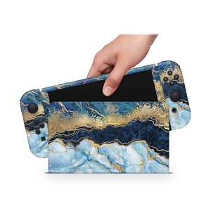 May include: A blue and gold marble design Nintendo Switch console skin. The skin is applied to the console and the Joy-Con controllers.