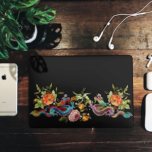 May include: A black laptop case with an embroidered design of two dragons and flowers. The dragons are blue, green, and red, and the flowers are orange, yellow, and pink.