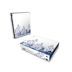 May include: A white Xbox Series X console with a blue and white design featuring a traditional Chinese porcelain pattern. The design includes stylized trees, buildings, and a landscape.