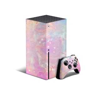 May include: An Xbox Series X console and controller featuring a galaxy-themed design in shades of pink, purple, and white. The console is a tall, rectangular shape, and the controller has a matching design.
