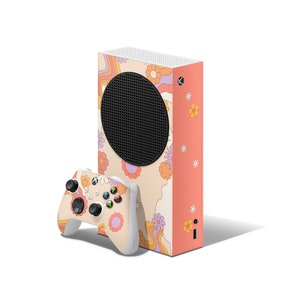 May include: A white Xbox Series X console with a colorful retro-inspired design featuring swirls and flowers. The console is paired with a white Xbox controller.