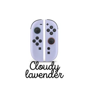May include: A pair of 'Cloudy lavender' coloured game controllers, each with black buttons and joysticks. The controllers feature a minimalist design with a plus sign, minus sign, and lettered buttons. The text "Cloudy lavender" is written below.