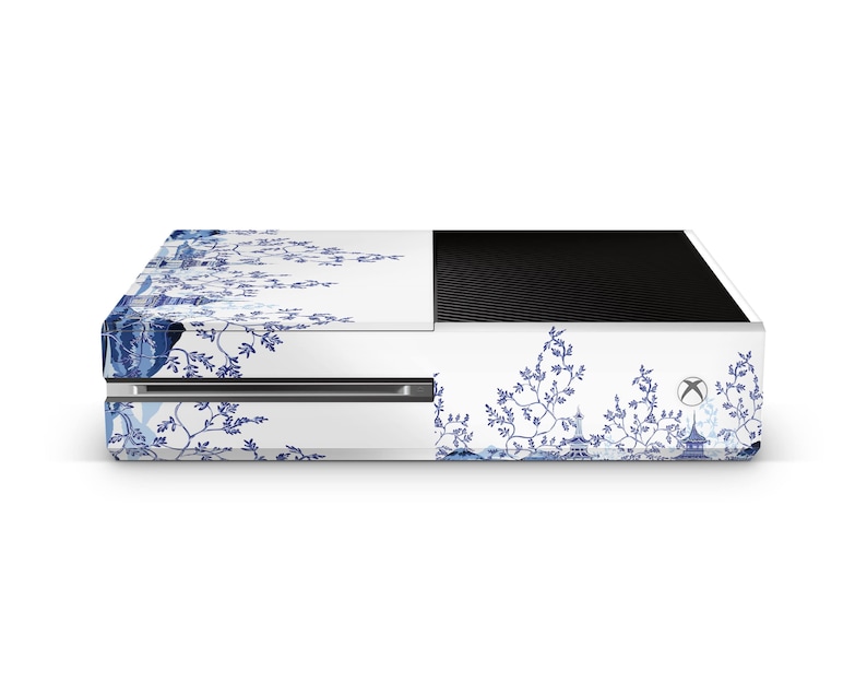 May include: White gaming console with a blue and white floral design. The console has a black top and a blue and white floral design on the front and sides.
