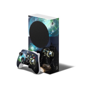 May include: A white Xbox Series X console with a custom skin featuring a dark blue background with a glowing blue and green design. A skeletal figure with glowing eyes is holding a glowing orb. The console is paired with a white Xbox controller.