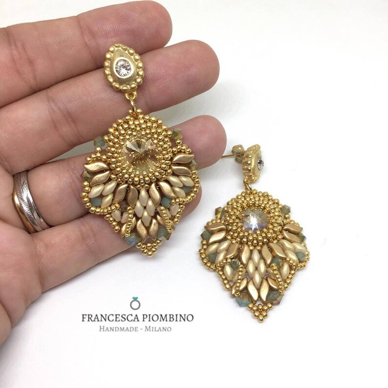 Hand-sewn gold earrings with beads and crystals.