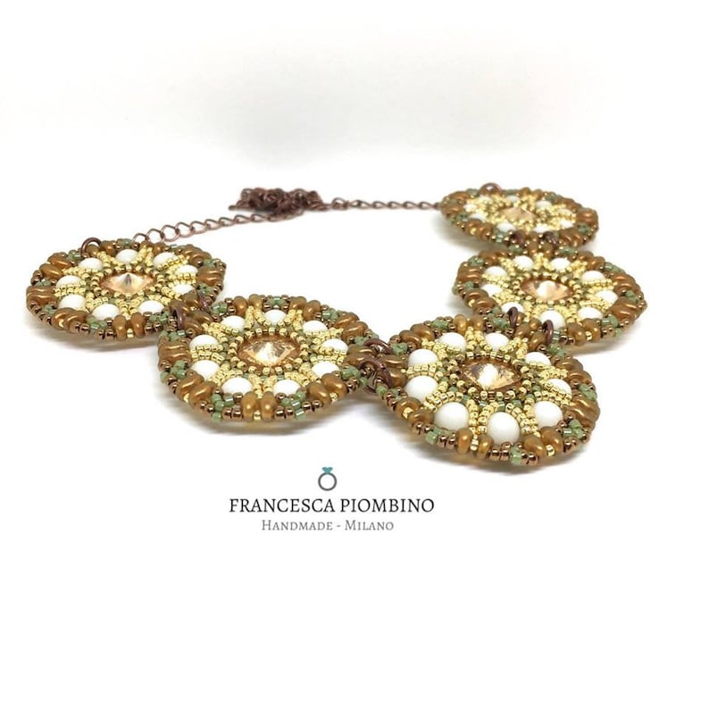 Hand-sewn choker with beads on white green and peach tones.