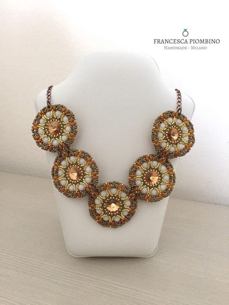 Hand-sewn choker with beads on white green and peach tones.