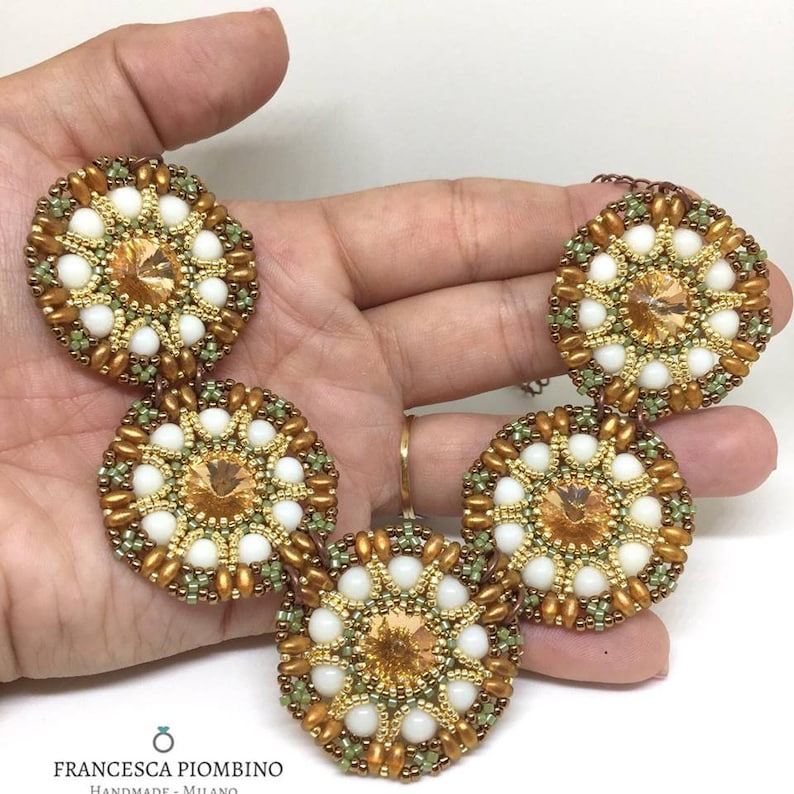 Hand-sewn choker with beads on white green and peach tones.